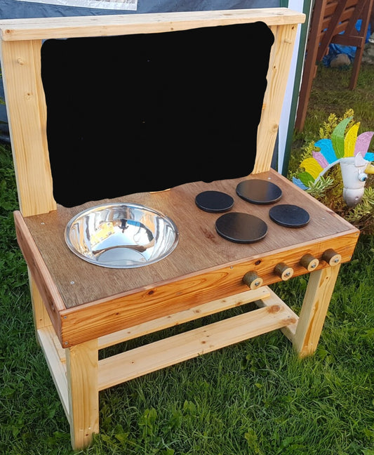 Small mud kitchen with blackboard