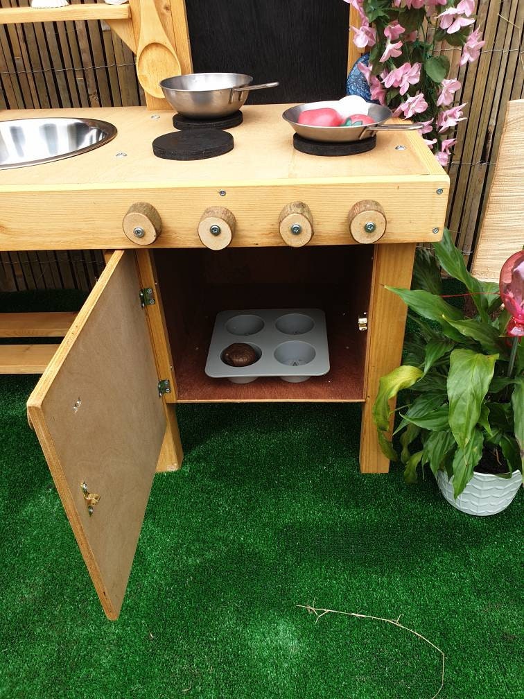 L shape mud kitchen with oven, blackboard and large worktop