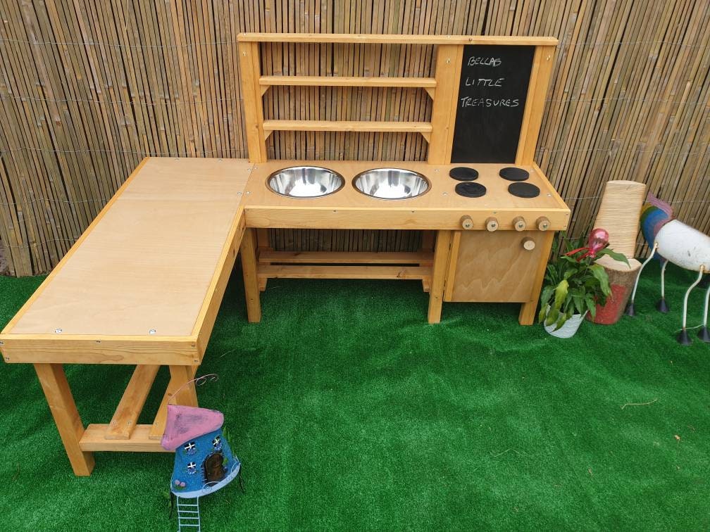 L shape mud kitchen with oven, blackboard and large worktop