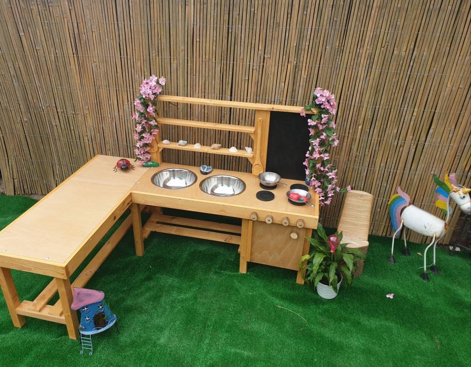 L shape mud kitchen with oven, blackboard and large worktop